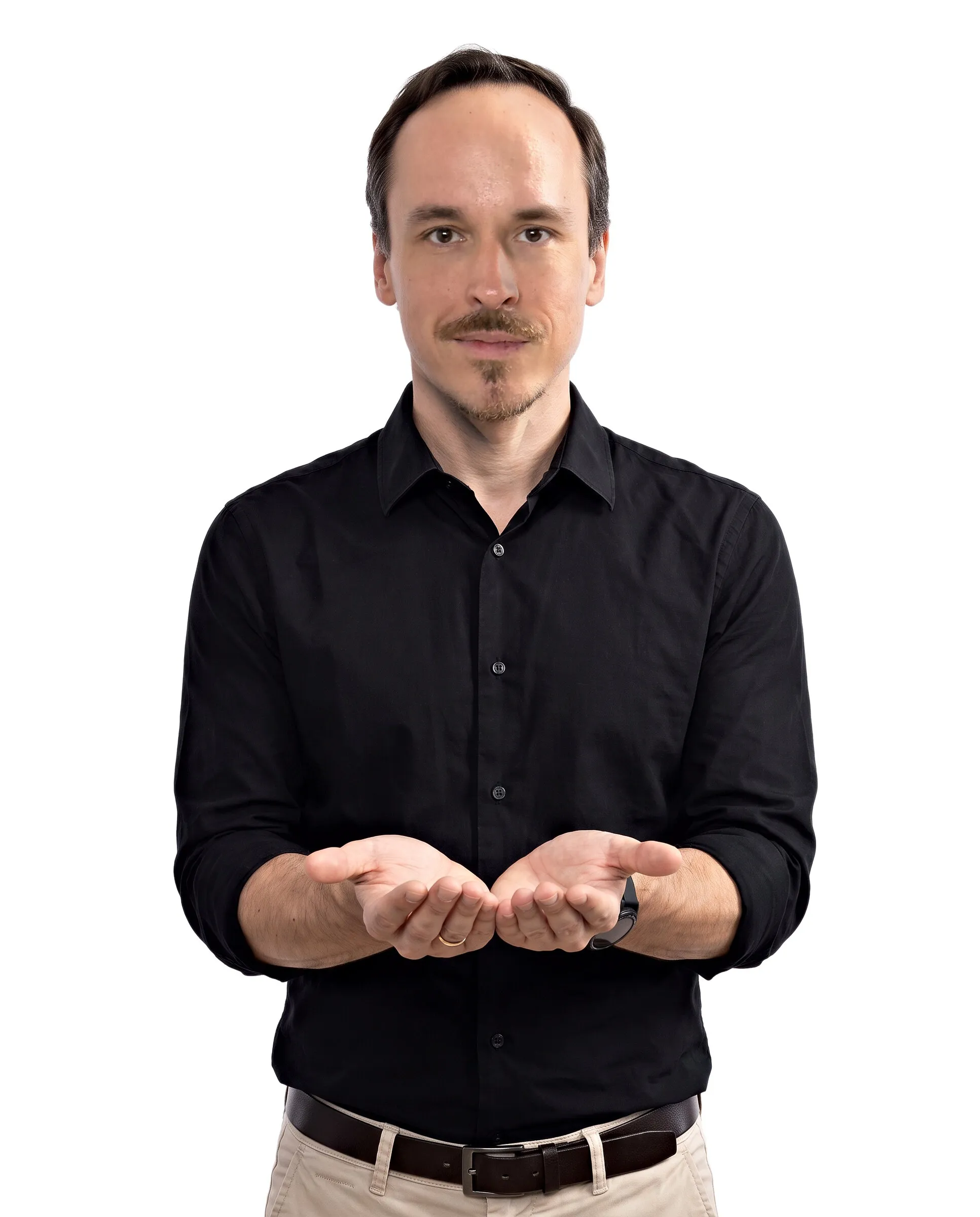 Krystian Gadomski in a white studio, holding out his open palms